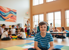 School-aged child wearing earmuffs or headphones in a busy environment and looking calmer and more regulated