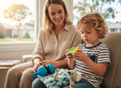 Parent and child using portable sensory tools and a small fidget during a calm everyday outing or waiting room visit