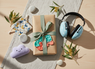 Thoughtful sensory gift set with a small pouch, quiet tactile fidgets, a squishy item and kids earmuffs on a tabletop in warm natural light