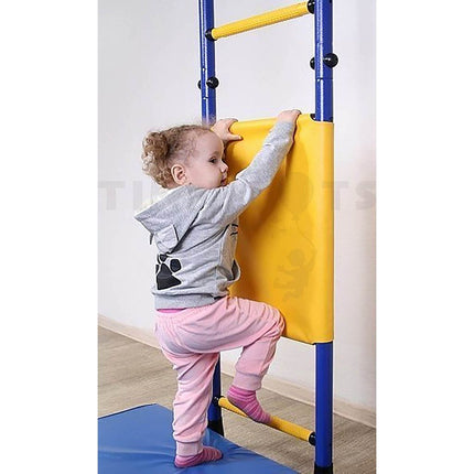 Young child climbing gym ladder with Swedish Wallbars Safety Covers in bright yellow, helping families thrive with tools to calm connect and support