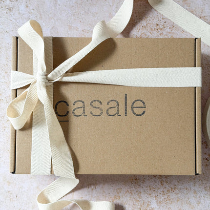 Honeylight Gift Box with natural cream fabric ribbon on kraft cardboard, helping families thrive with calm tools