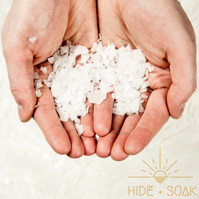 Hands holding white flakes of Franki #1 - Sports Recovery - Magnesium Flakes Bath + Foot Salts | Single Use Pack 150g