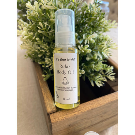 Relax Body Oil Massage and Moisturise bottle with natural green plants, helping families thrive with calm support.