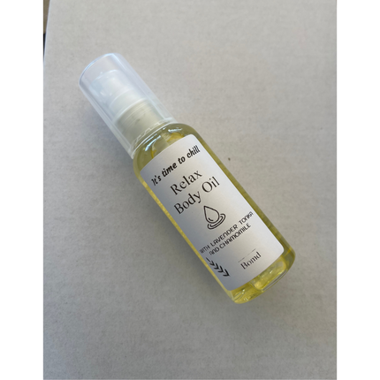 Clear bottle of Relax Body Oil Massage and Moisturise with lavender and chamomile on a neutral background
