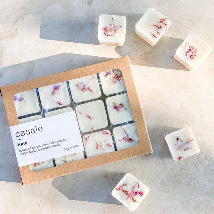 12 LIMA BOTANICAL SOY WAX MELTS with dried flower petals in a natural kraft box, helping families thrive with tools to calm, connect and support