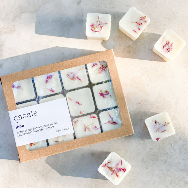 12 LIMA BOTANICAL SOY WAX MELTS with dried flower petals in a natural kraft box, helping families thrive with tools to calm, connect and support