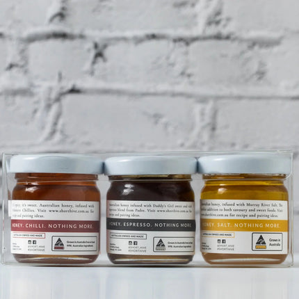 Honeylight Gift Box featuring three jars of Australian honey with chili, espresso, and Murray River salt flavors. Helping families thrive with tools to calm, connect and support.