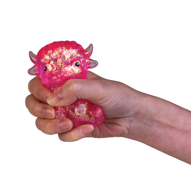 Highland Cow Smooshos Super Squeeze pink glittery squishy toy held in hand
