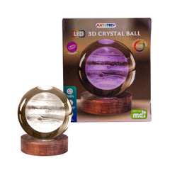 Jupiter 3D Crystal Ball Lamp glowing with LED lights on a wooden base next to its packaging box.