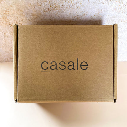 Closed brown cardboard box with Casale logo, containing the SUNDAY MORNING GIFT BOX to calm, connect and support.