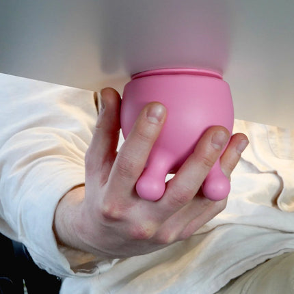 Hand holding pink Bubblegum Stuff - Office Udders sensory fidget tool helping families thrive with tools to calm, connect and support