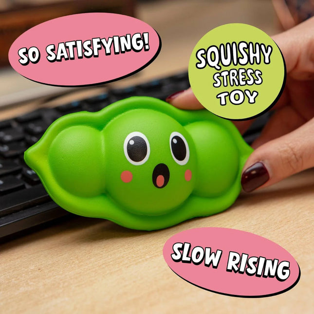 Green pea pod shaped Stress Toy - Squeazy Peasy held by hand on desk near keyboard for calming sensory play