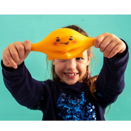 Child holding and stretching a yellow Stress Toy - Jellysquish with a smiling face, promoting calm and fun.