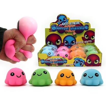 Hand squeezing a pink Squeeze Octopus fidget with colorful squishy octopus toys in display box behind