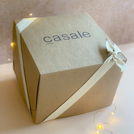 MELTING MOMENTS GIFT BOX wrapped in ribbon with warm fairy lights, helping families thrive with tools to calm connect support