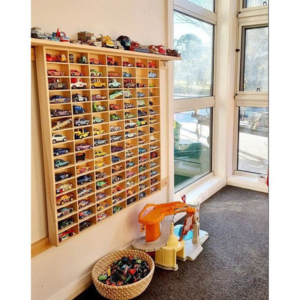 JCAR 105 — Diecast Display Rack mounted on wall with colorful toy cars in a sunny playroom setting.