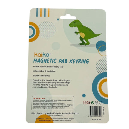 Packaging for Dinosaur Magnetic Pad Keyring featuring a green dinosaur illustration and product details highlighting its sensory and portable features.