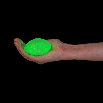 Smoosho's Super Squeeze Glow-in-the-dark Diamond glowing green sensory squishy held in an open hand