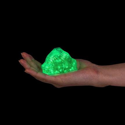 Smoosho's Super Squeeze Glow-in-the-dark Iceburg glowing green sensory squishy in a hand