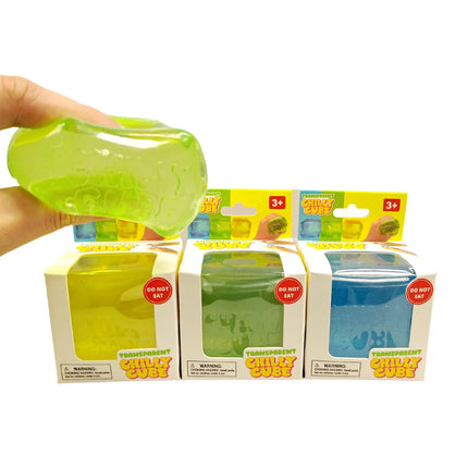 Chilly Cube Transparent sensory squishy toy shown in green with boxed blue and yellow cubes