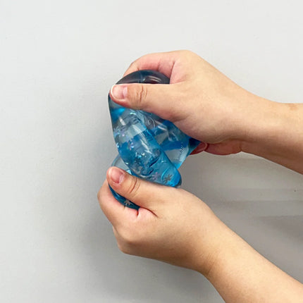 Chilly Cube Snowflake blue squishy being squeezed in both hands