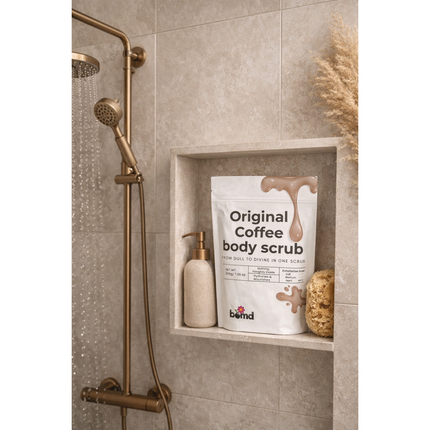 Coffee Body Scrub Original Warm Vanilla Blend in shower niche with soap dispenser and natural sponge, helping families thrive.