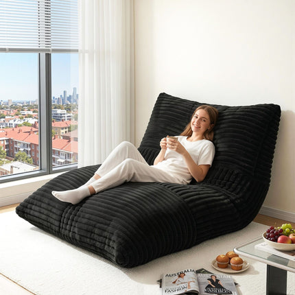 Woman relaxing on Artiss 3-in-1 Bean Bag Chair for Living Room Convertible Floor Sofa Dark Grey by a window in a bright room
