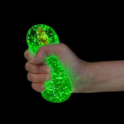 Smooshos Super Squeeze Diamond Sphere GID Quokka glowing green sensory squishy held in hand against black background