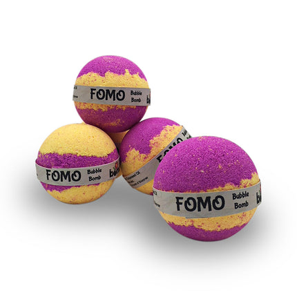 Four FOMO Fun Fizzy Colourful Bubble Bath Bombs with purple and yellow swirls on a white background