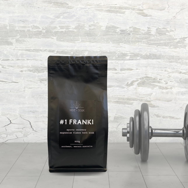 #1 Franki - Sports Recovery - Magnesium Flakes Bath Salts | 900g black pouch next to grey dumbbell on tiled floor