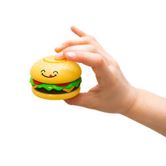 Child's hand holding a smiling Fidget Spinner - Cheeseburger sensory toy designed for calming and focus.