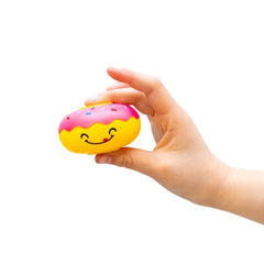 Hand holding a colorful smiling Fidget Spinner - Donut with pink frosting and sprinkles on white background