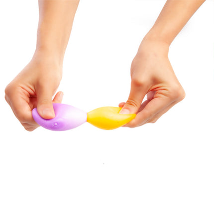 Hands stretching purple and yellow Smoosho's Sticky Splat Ballz - Set of 3 sensory fidget toys on white background.