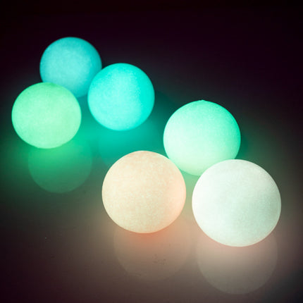 Smoosho's Glow-in-the-Dark Sticky Splat Ballz - Set of 3 glowing sensory fidget balls in various colors on dark background