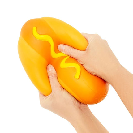 The Big Squij Hot Dog sensory squishy toy held and squeezed in two hands