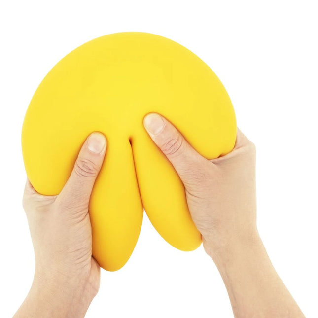The Big Squij Fortune Cookie yellow squishy fidget toy held and squeezed by hands
