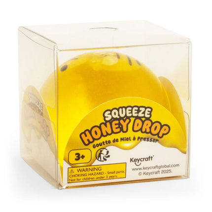 Honey Drop Ball yellow squeeze fidget toy in clear display box