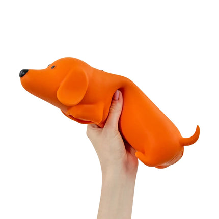 The Big Squij Dachshund Slow-Rise Squishy Toy held in one hand