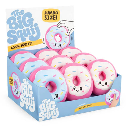 Display box filled with pink and blue donut shaped squishies with smiling faces and colorful sprinkles
