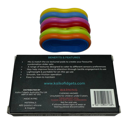 Mag Sliders - Six Interchangeable Magnetic Textured Pad Fidgets in bright colors stacked on product packaging box