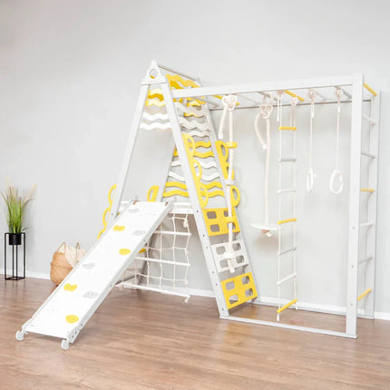 Wooden Teepee Playground indoor climbing gym with slide, rope ladder, rings, and swing for kids' sensory play.