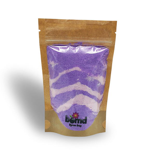 Love Spell Fizzing Bubble Bath Dust in purple and white layers, sensory bath product to calm and connect.