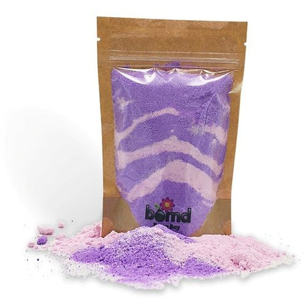 Love Spell Fizzing Bubble Bath Dust in purple and pink powder, helping families thrive with calm and support.