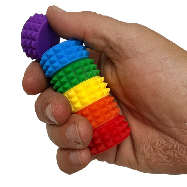 Hand holding MagStak Core - Textured fidget stack with colorful, textured sensory rings for tactile stimulation.