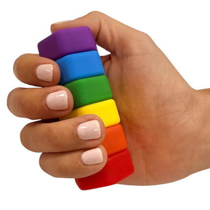 Hand holding colorful stack of magnetic smooth blocks for fidgeting called MagStak Hive - Smooth