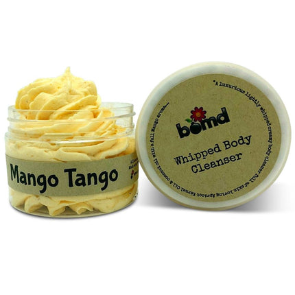 Mango Mango Whipped Body Cleanser in a jar with creamy yellow texture, promoting calm, connection, and support.