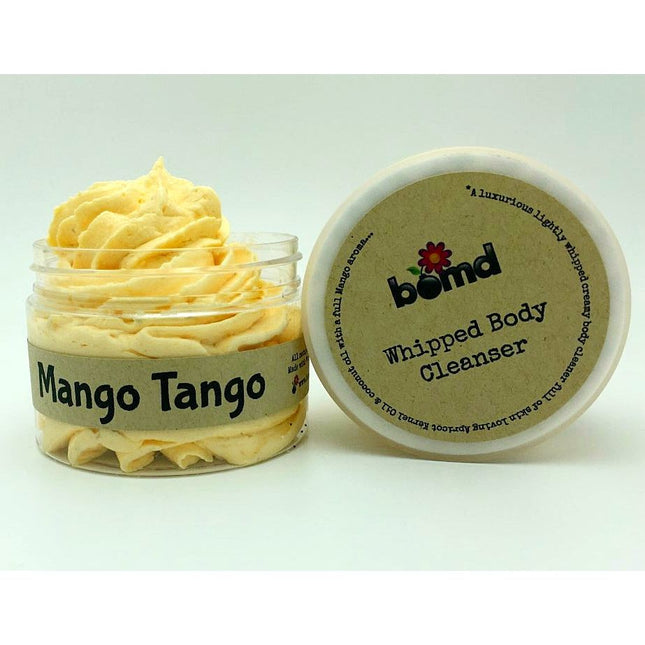 Mango Mango Whipped Body Cleanser in an open jar showing light creamy texture and soft whipped appearance