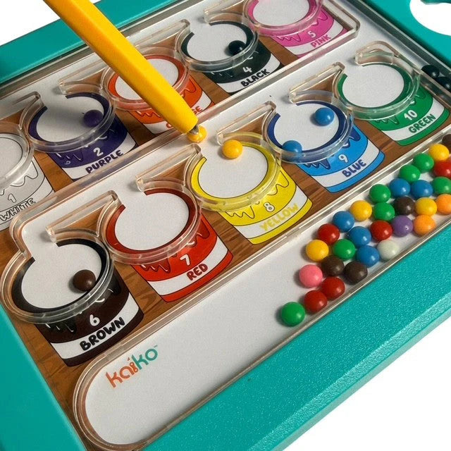 Close-up of a Colour & Number Maze Magnetic Pad - Magnetic Colour Sorting Maze showing colorful magnetic beads being placed into corresponding numbered and colored paint pots with a yellow magnetic wand.