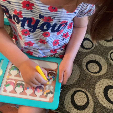 Child using a yellow stylus to move colorful magnetic beads inside sections of the Colour & Number Maze Magnetic Pad - Magnetic Colour Sorting Maze toy.