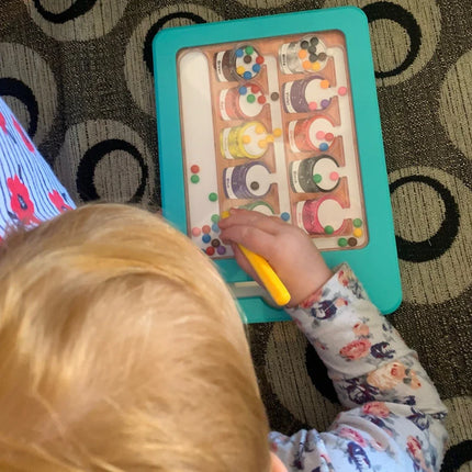Child playing with the Colour & Number Maze Magnetic Pad - Magnetic Colour Sorting Maze, sorting colorful magnetic pieces into matching sections.